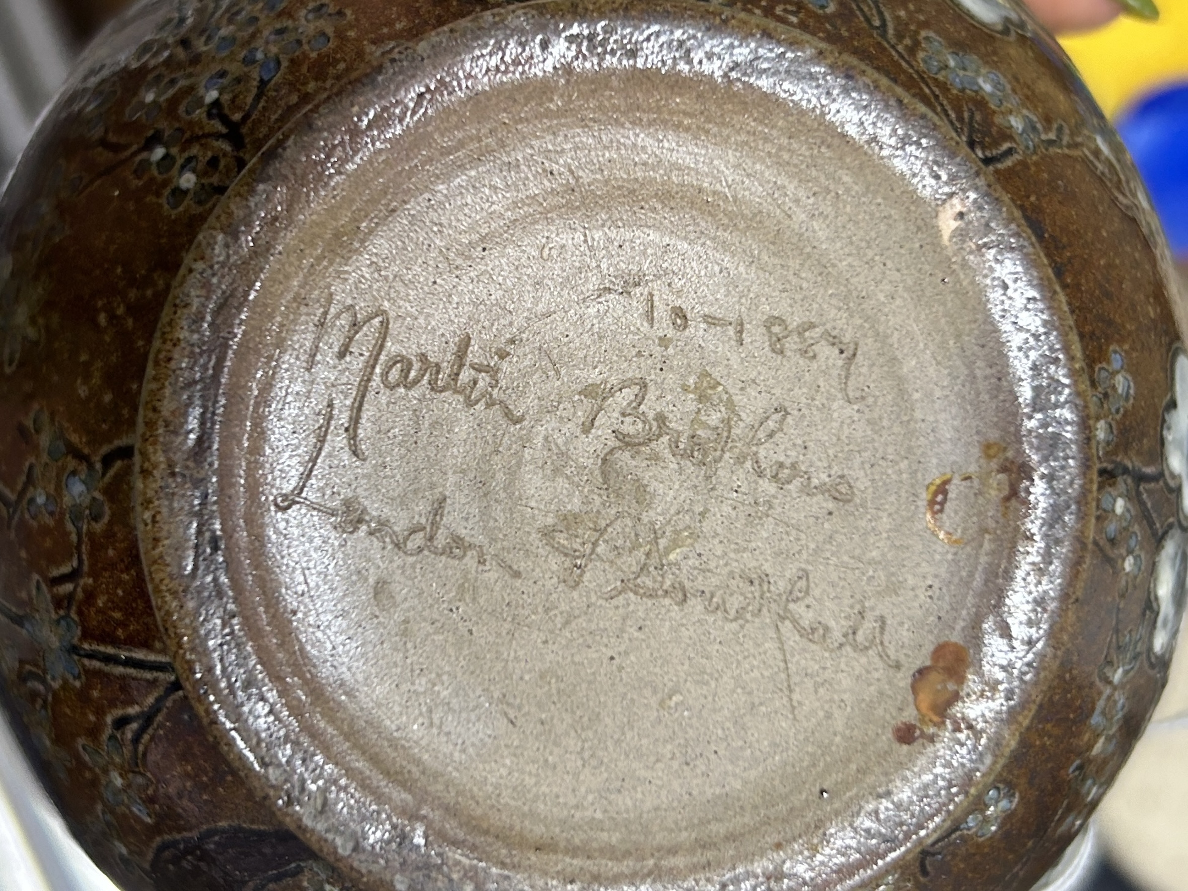 Martin Brothers: A stoneware jug decorated with flowers